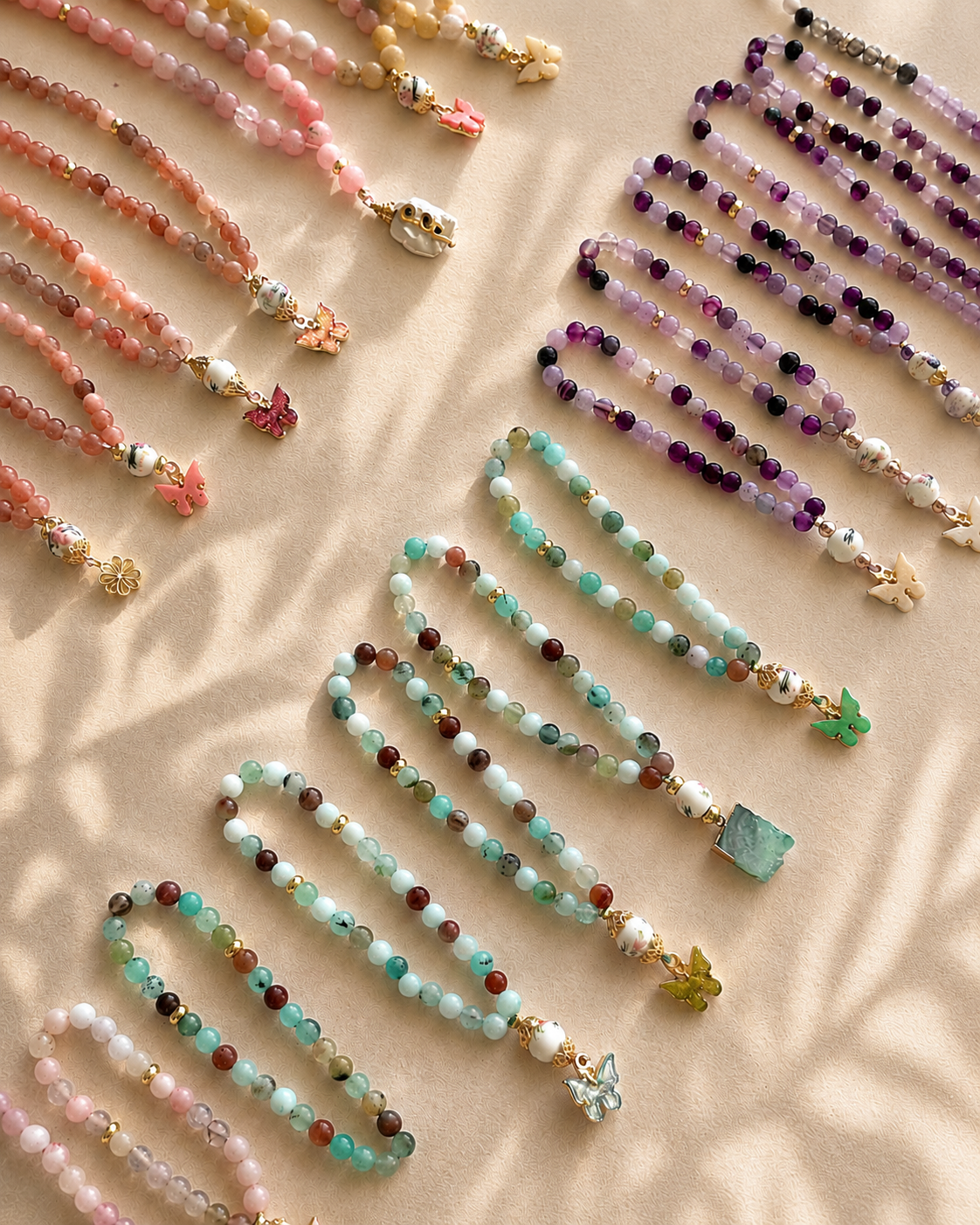 Natural rose quartz and amazonite prayer beads on cream marble — SAYSIRI
