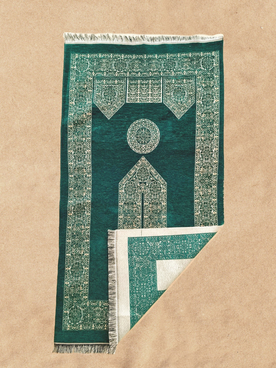 Emerald green Mecca Collection prayer mat with corner folded to show the weave