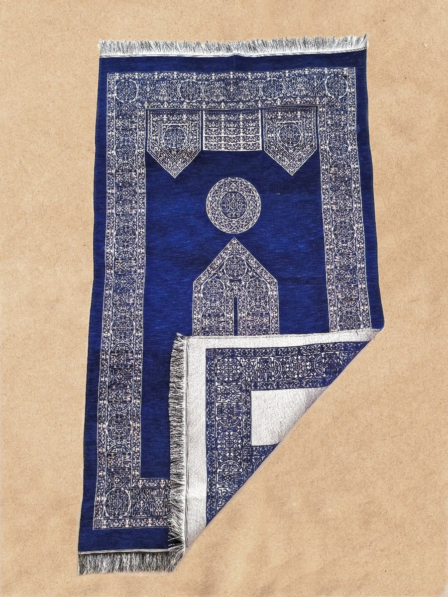 Royal Blue Mecca prayer mat with corner folded showing the soft underside