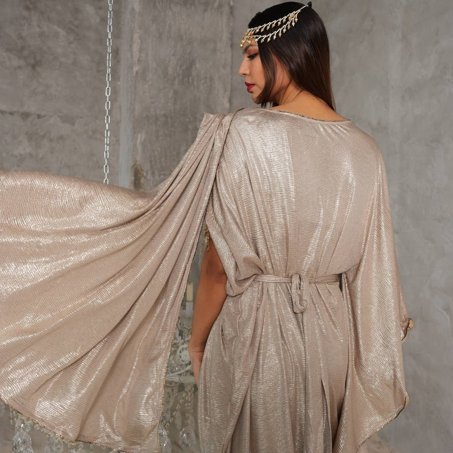 Back view of the Athena Gold Crepe Maxi Dress showing the flowing cape sleeve
