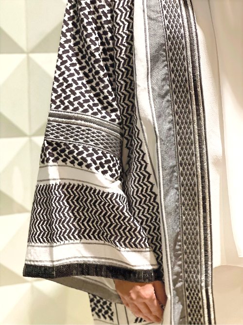 Close-up of the black and white keffiyeh weave fabric and silver-thread trim on the SAYSIRI kimono