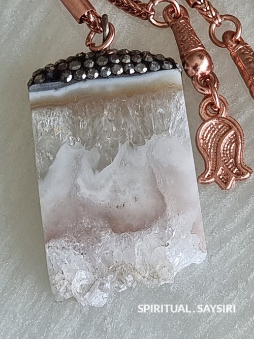 Close-up of the rose quartz pendant and rose gold charms on the tasbih