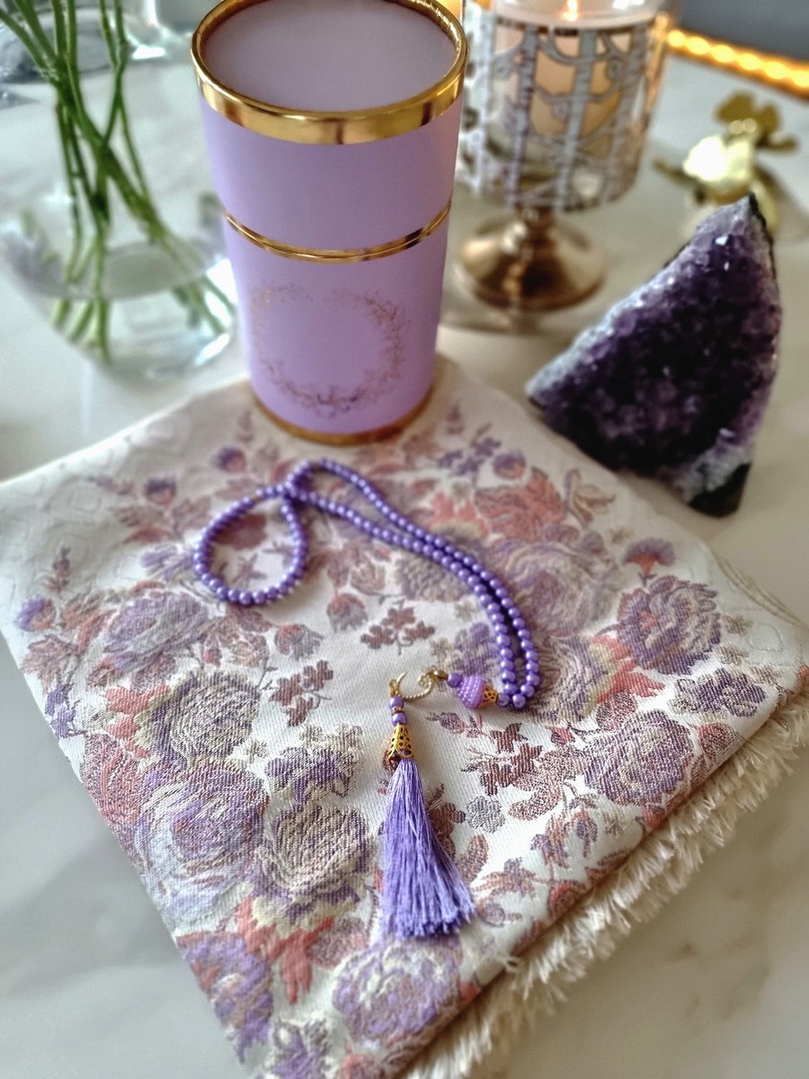 Lavender Safia floral prayer mat styled with tumbler and lavender prayer beads