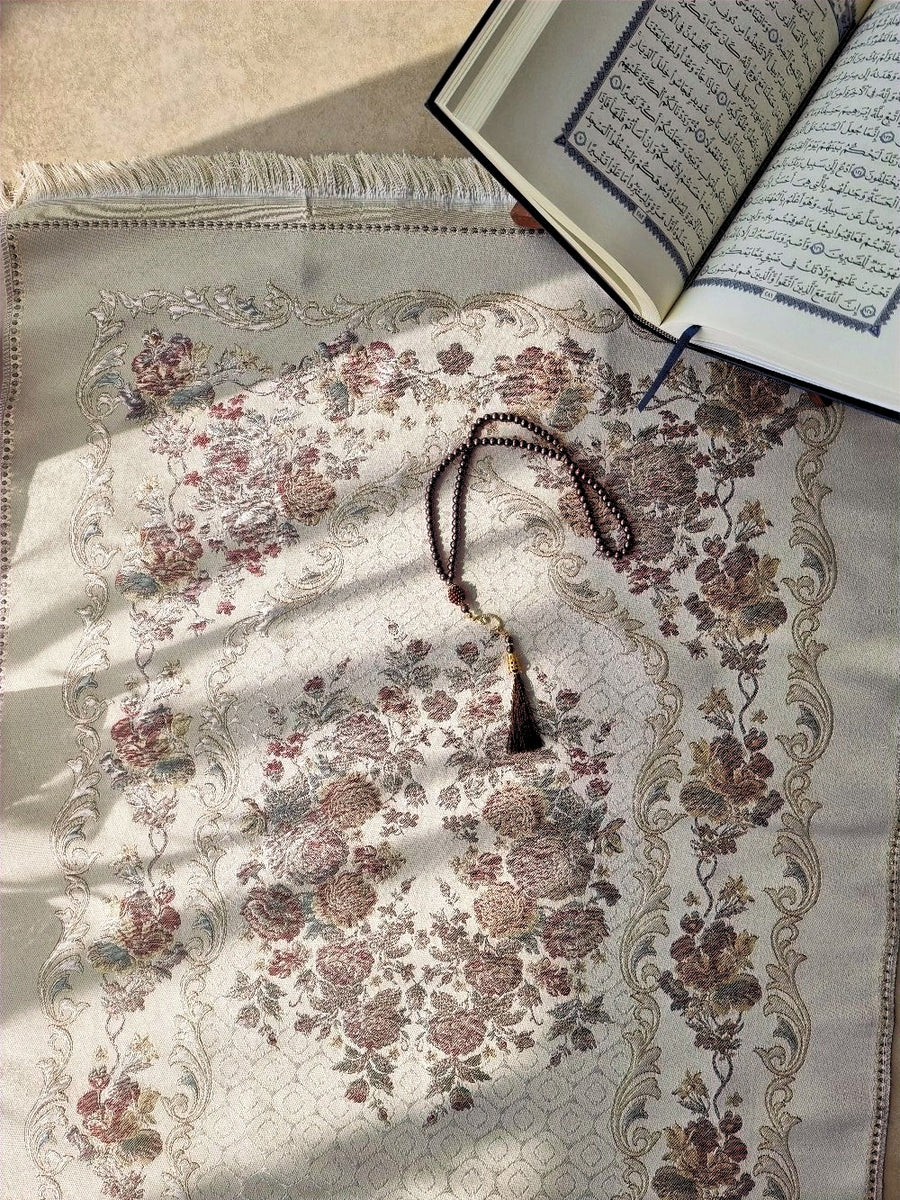 Rose Zahraa floral prayer mat with Quran, overhead view