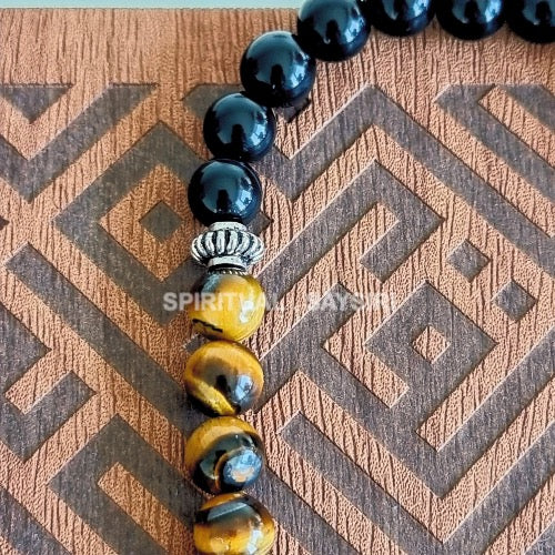 Close-up of black onyx and golden tiger eye gemstone beads