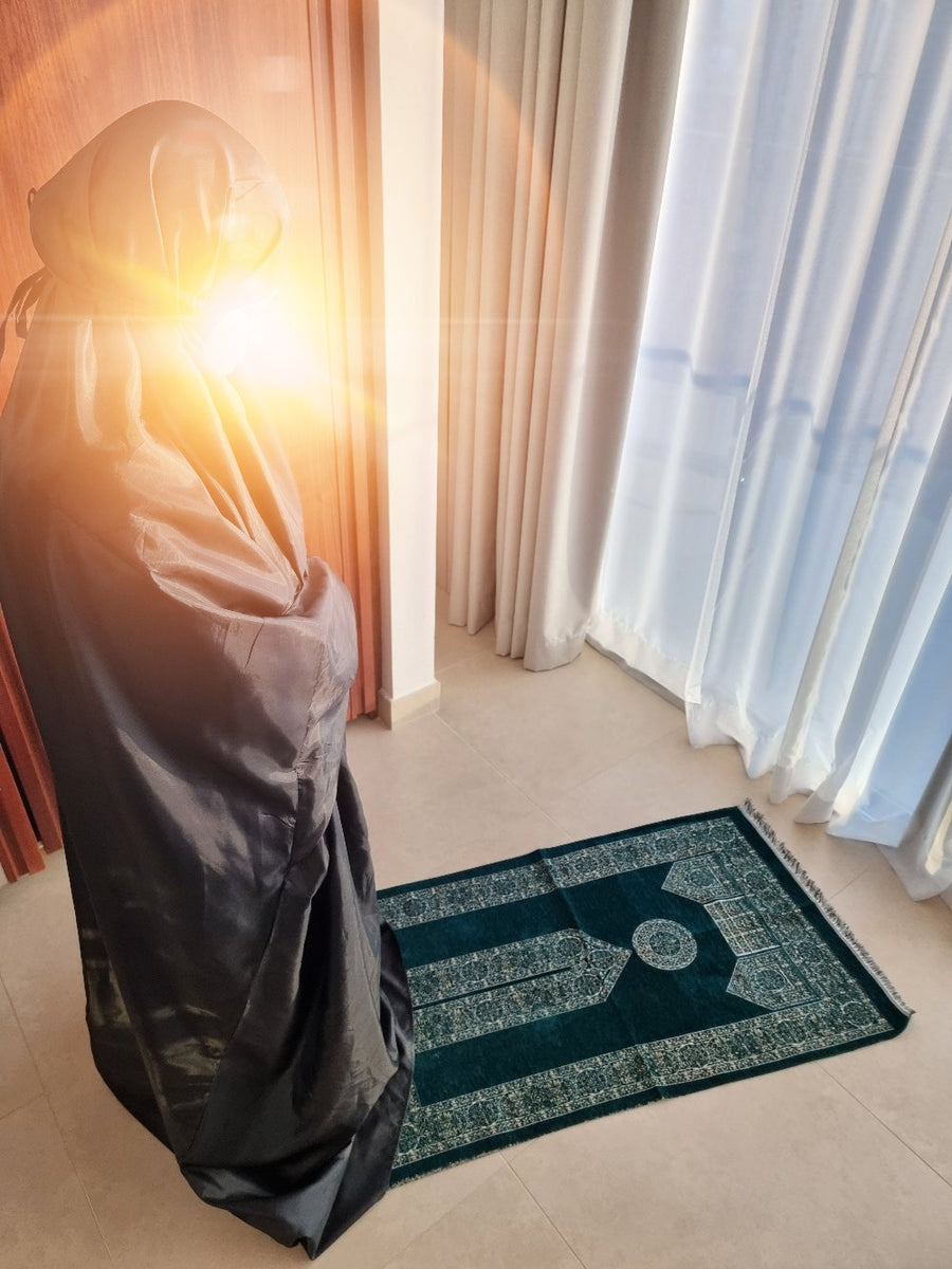 Praying at sunrise on the Mecca Collection sajadah by the window