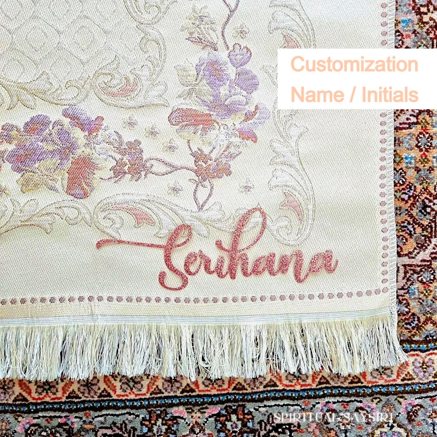 Custom name embroidery example on the Safia floral prayer mat fringe