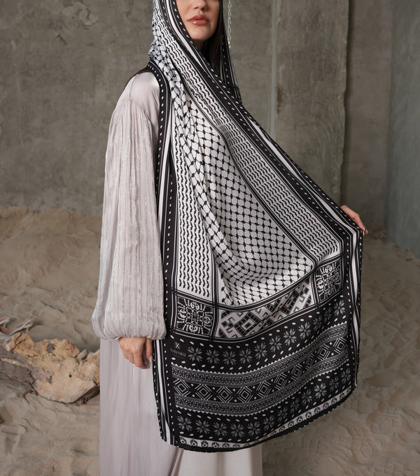 Model draped in the Tatreez Keffiyeh Scarf — black and white Palestinian embroidery-inspired print