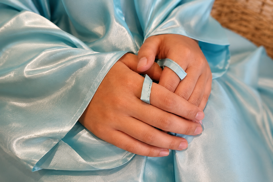 Finger loop detail keeps the prayer dress sleeve in place