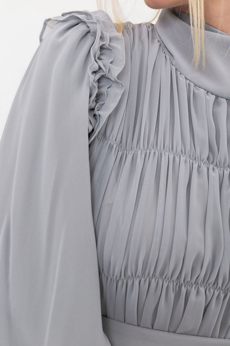 Close-up of the Dove Ethereal Edit dress showing the soft chiffon texture and powdery grey neutral tone.
