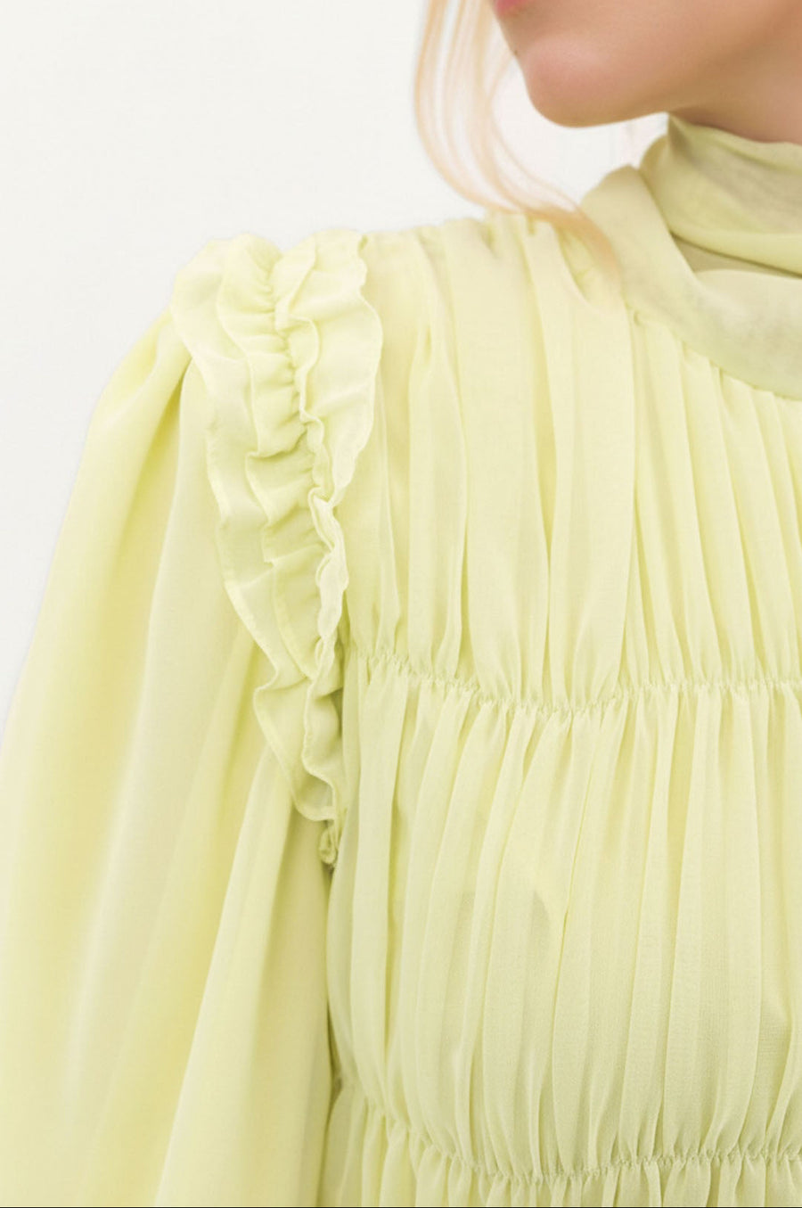 Close-up of the Primrose Ethereal Edit dress showing the soft chiffon texture and delicate primrose yellow tone.