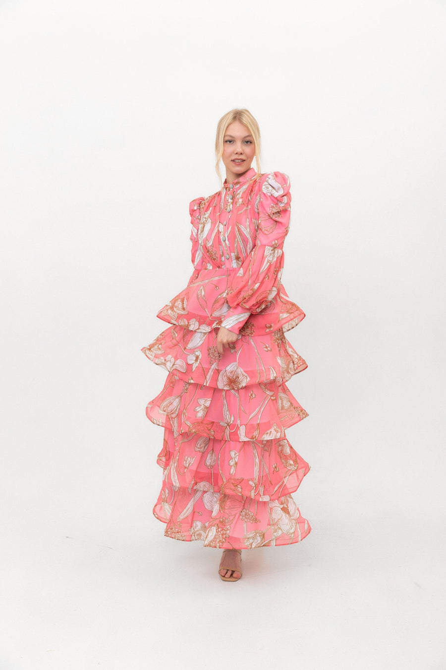 The Bloom Edit tiered chiffon dress in Coral Pink, in motion with the tiers flaring.