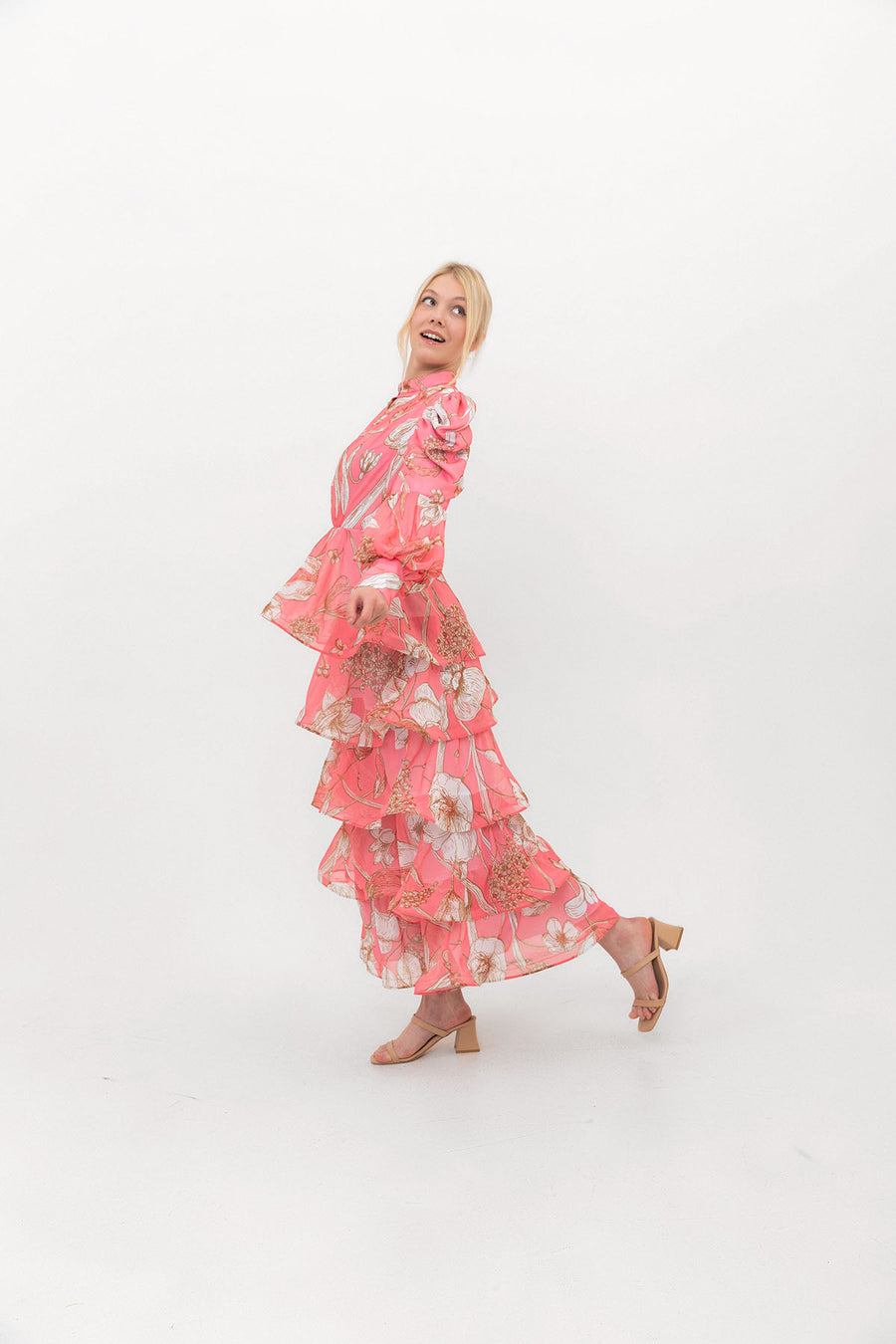 The Bloom Edit tiered chiffon dress in Coral Pink, side view showing the layered tiers.